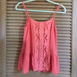 Peach camisole with lace insert on the front.